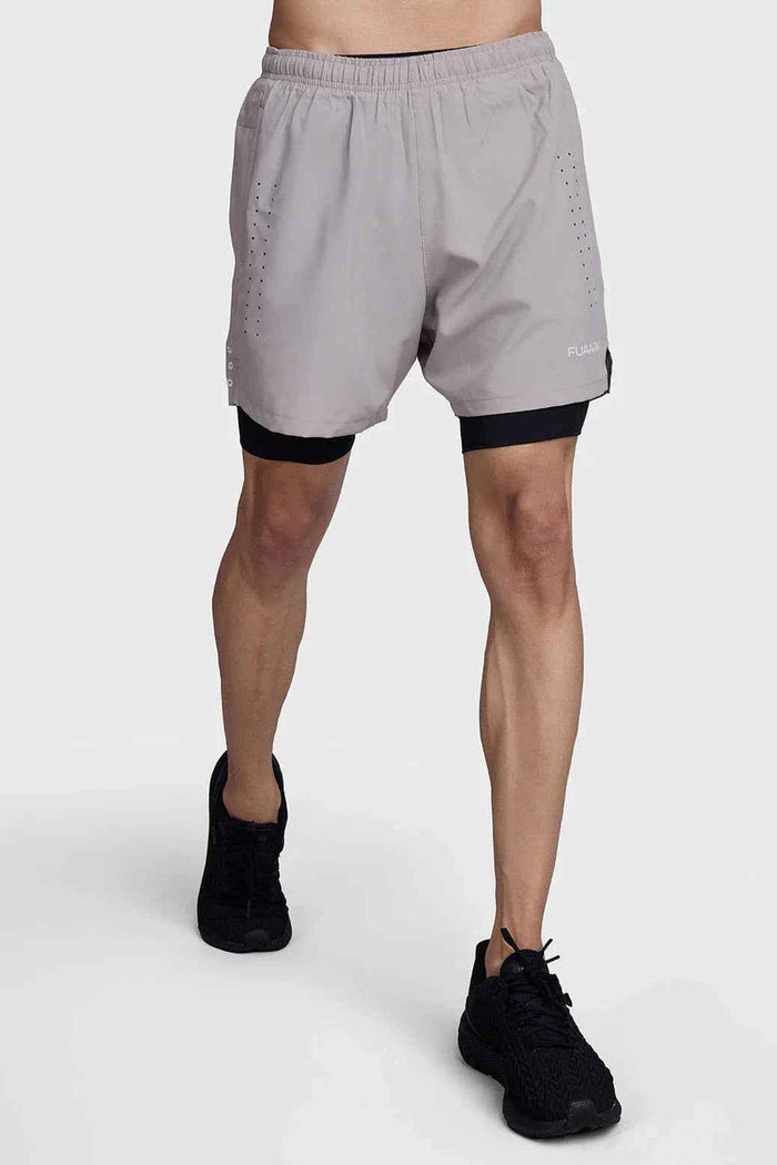 Beige and black 2-in-1 laser shorts by Fuaark Nz, featuring a stylish design and versatile fit, shown on a model.