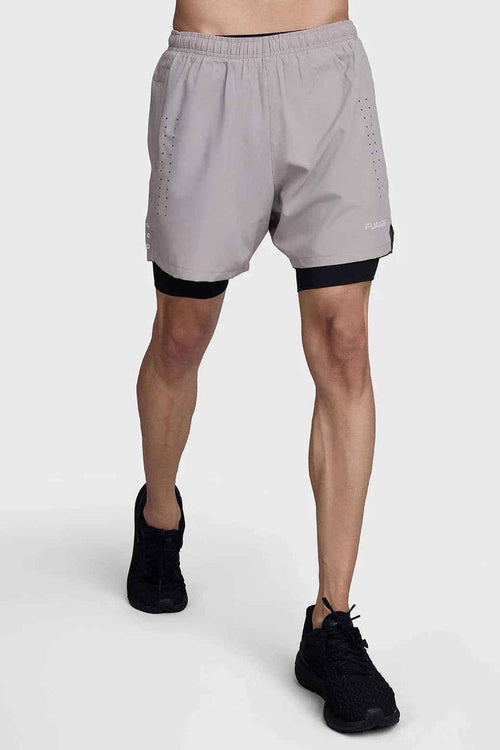 Beige and black 2-in-1 laser shorts by Fuaark Nz, featuring a stylish design and versatile fit, shown on a model.