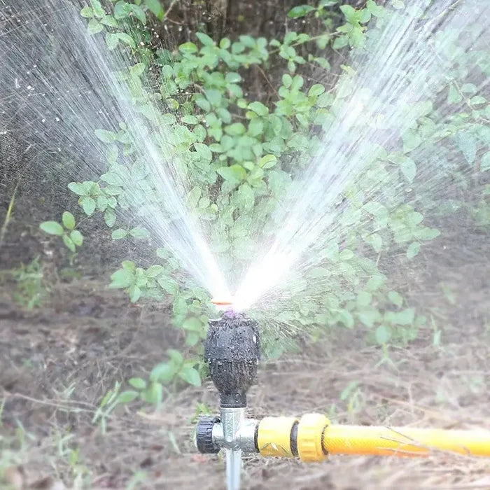 Habicare 360° rotating garden sprinkler on tripod irrigation stand, providing even watering coverage for lawns and gardens.