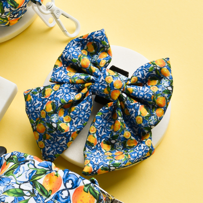 Bright yellow sailor bow tie with blue, yellow, and orange floral pattern by Cocopup London.