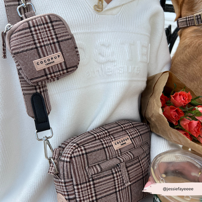 Person in white top holds roses and wears a plaid Cocopup London dog walking bag with matching treat pouch.