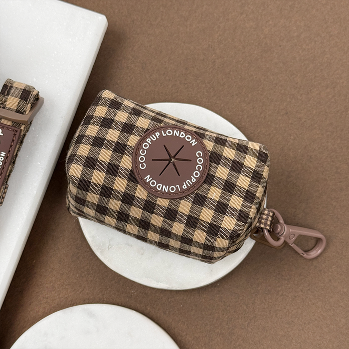 Brown and tan checkered poop bag holder with zipper and clip, featuring Cocopup London label.