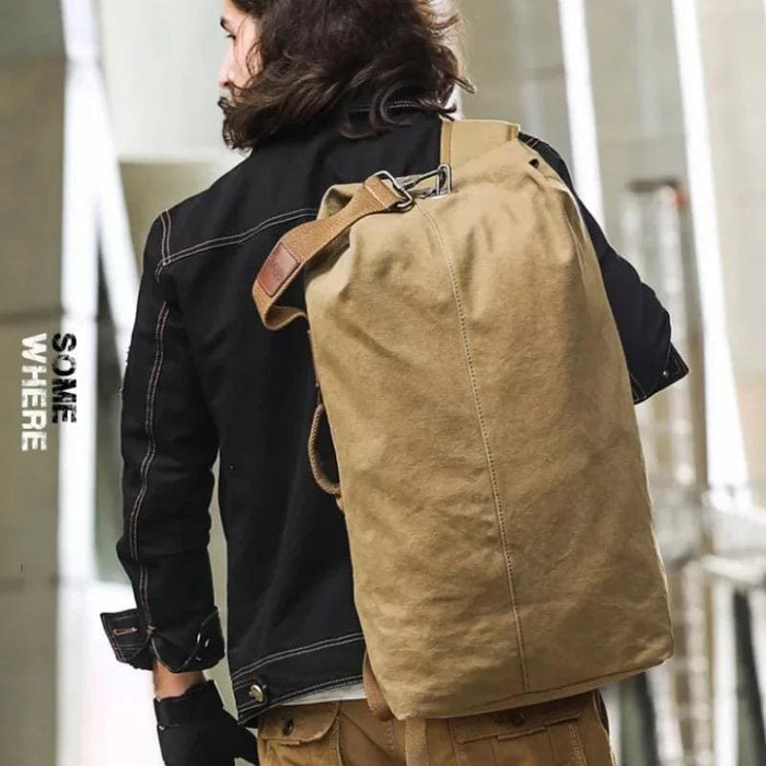 9eight5 duffel bag and backpack hybrid with adjustable straps and multiple compartments, shown in black fabric.