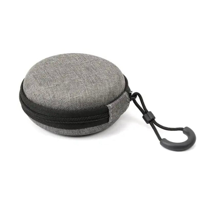 9eight5 earphones case in round shape, compact electronics accessory with soft exterior and secure zipper closure.
