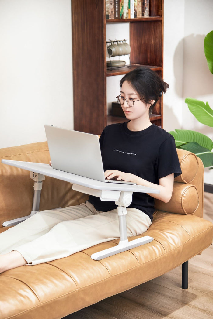 Foldable Ergomax Laptop Desk by sue-e furniture, showing a compact, adjustable office desk with a wooden finish in a modern workspace.