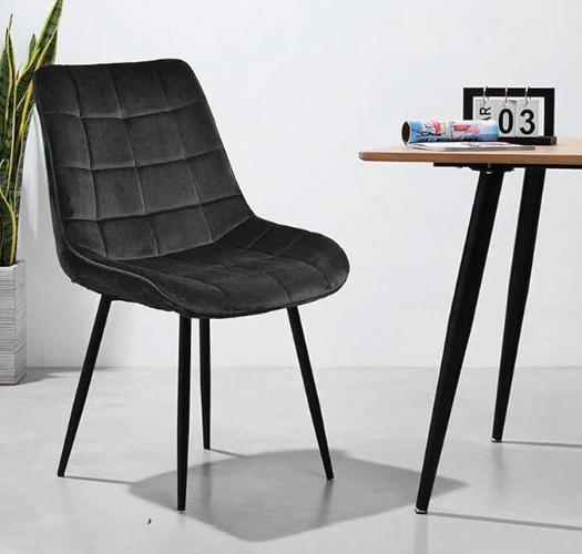 Black velvet Gavin dining chair by sue-e furniture, showcasing modern design and plush upholstered seating.