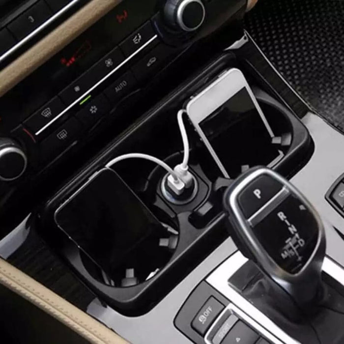 9eight5 Griffin car charger plugged into a vehicle's power outlet, with USB ports for charging phones and tablets.