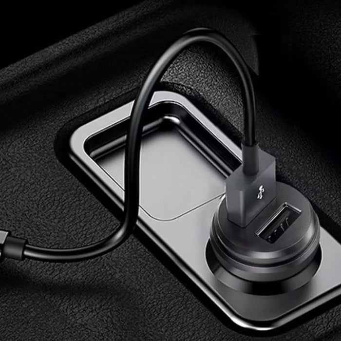 9eight5 Griffin car charger plugged into a vehicle's cigarette lighter port, charging a phone or tablet.