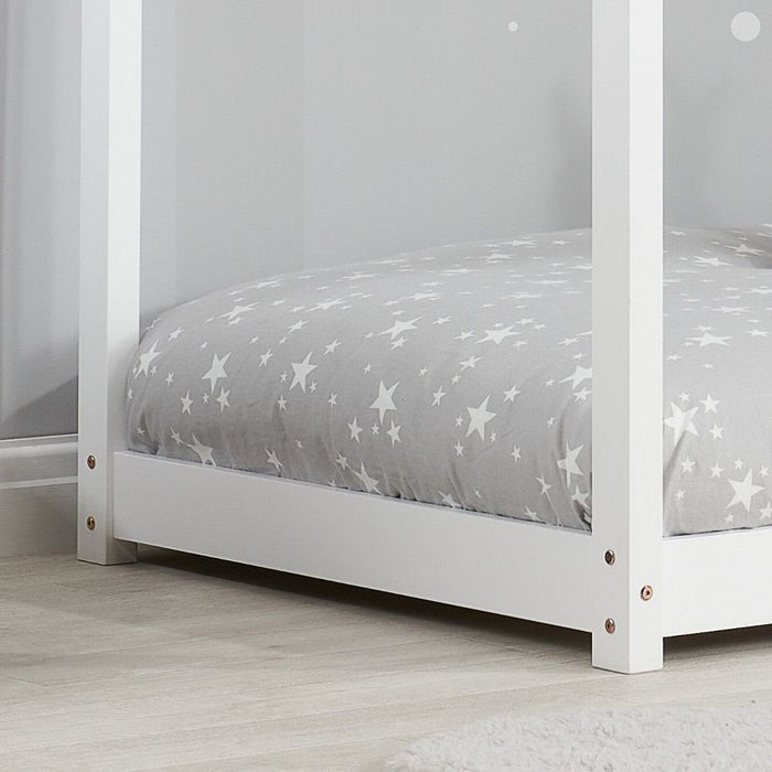 White single kid bed frame from Sue-e Furniture, featuring a sturdy design with a clean, modern look in a cozy bedroom setting.