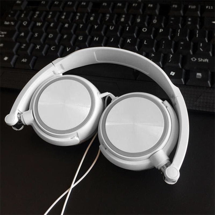 White 9eight5 headphones with black lighting, designed for electronics accessories, shown on a computer setup.