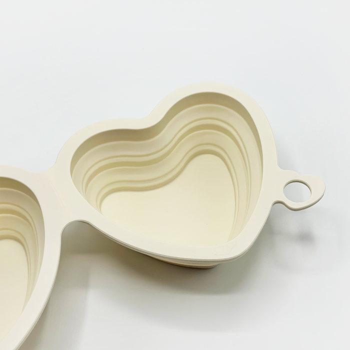 Cream heart-shaped collapsible pet bowl with handle from Cocopup London.