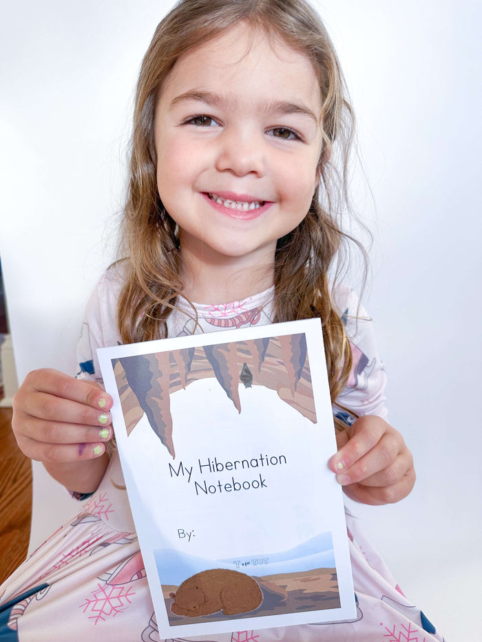 Child completing activities in hibernation notepad with included pen