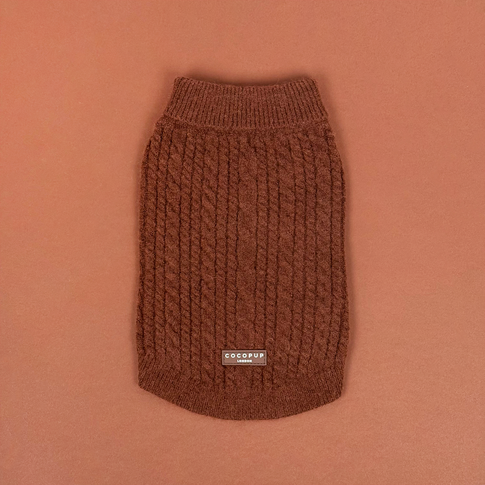Rust-colored cable knit dog jumper with a cozy, textured finish.