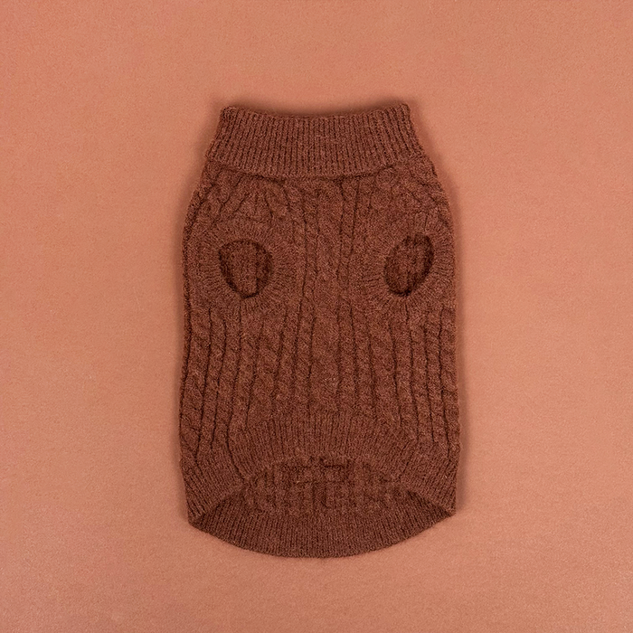 Brown cable knit dog jumper with two leg openings, shown on a matching brown background.