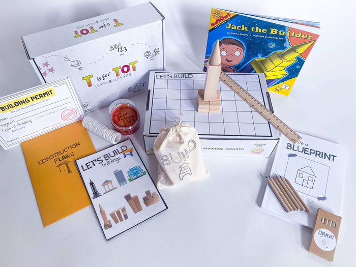 Kids' building-themed play kit with non-toxic playdough and brick playdough roller. Includes construction plans, building blocks, blueprint journal with ruler, and role play items like building permits and caution tape for imaginative play.