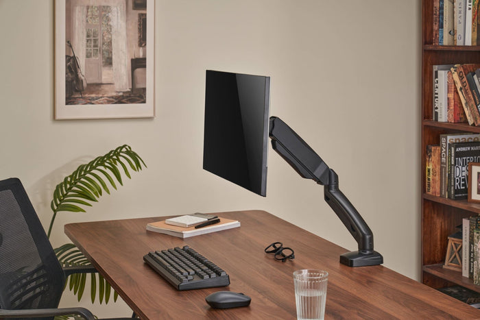 Sue-e Furniture Locktight spring-assisted monitor mount arm attached to a desk, providing adjustable support for computer screens.