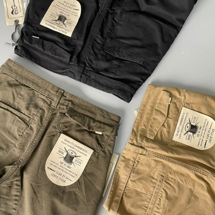 Black men's cotton pants with a relaxed fit, available in sizes 32 to 38, shown on a model with a casual style.
