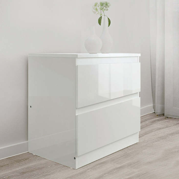 White Monaco bedside table by sue-e furniture featuring a sleek design and storage drawer, placed in a modern bedroom setting.