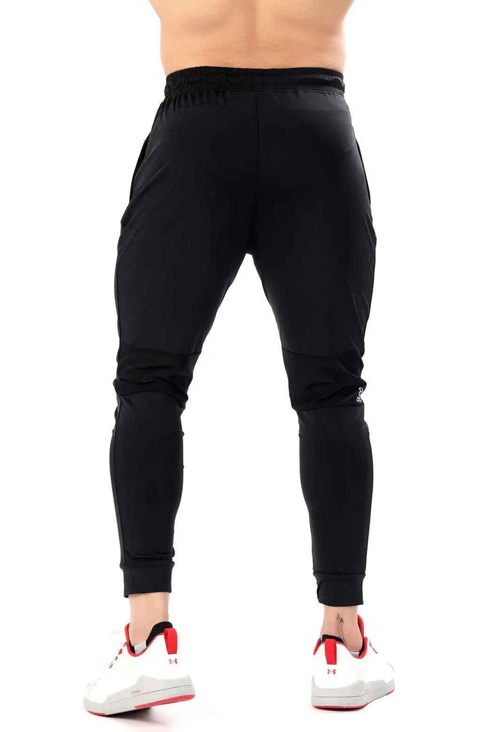 Black nylon joggers by Fuaark Nz featuring a sleek design and comfortable fit, perfect for casual and athletic wear.