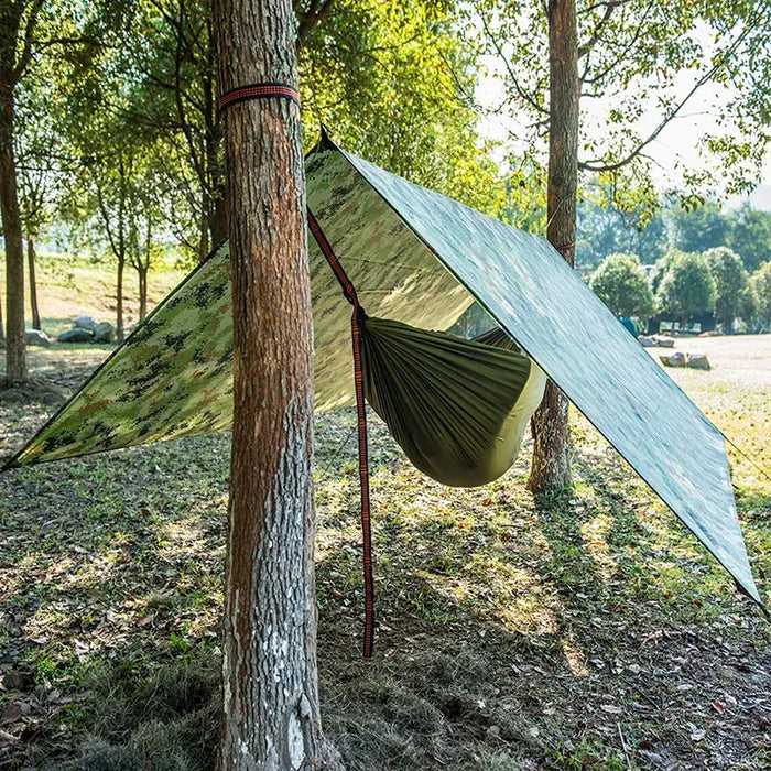 Habicare outdoor waterproof rain shelter tarp set up as a camping sun and rain shelter, providing waterproof protection for outdoor activities.