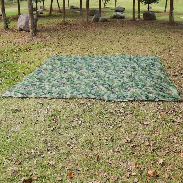 Habicare outdoor waterproof rain shelter tarp set up outdoors, providing sun and rain protection at a beach or camping site.