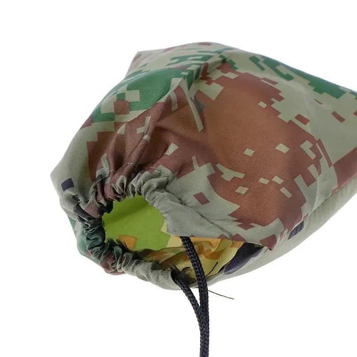 Habicare outdoor waterproof rain shelter tarp set up as a beach awning and camping sun shelter in a natural outdoor setting.