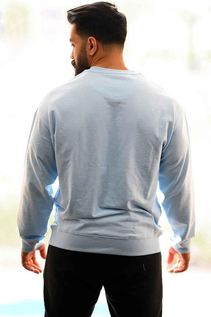 Sky blue oversized Fuaark NZ sweatshirt with a relaxed fit, soft fabric, and casual style, perfect for comfort and everyday wear.