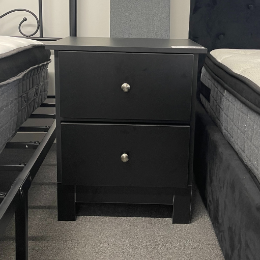 Black 'Pamela' bedside table by sue-e furniture with a sleek modern design and a single drawer for bedroom storage.