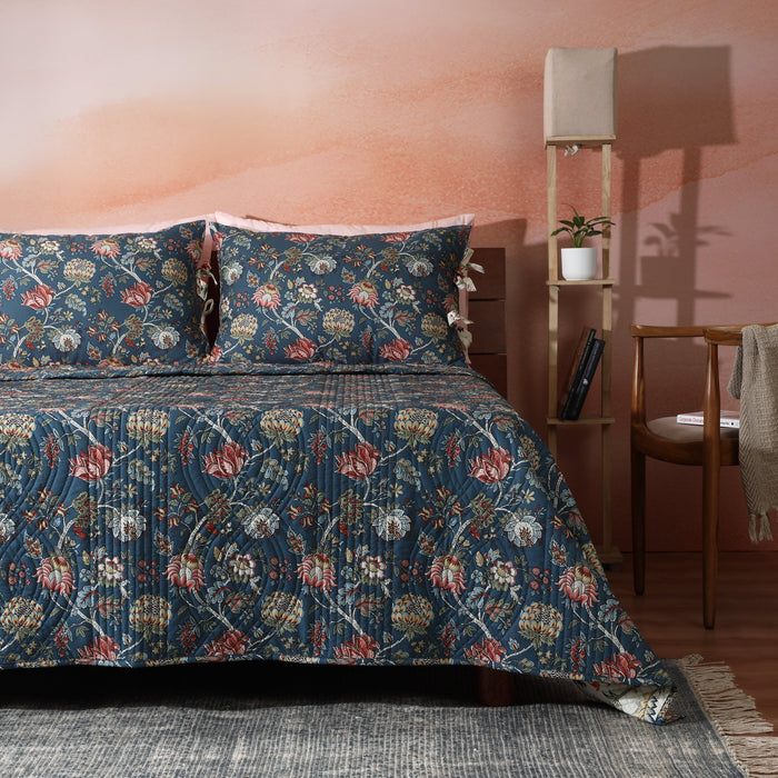 Reversible quilt set with chintz pattern by Whites of London NZ, featuring a soft, elegant percale fabric in a cozy bedroom setting.