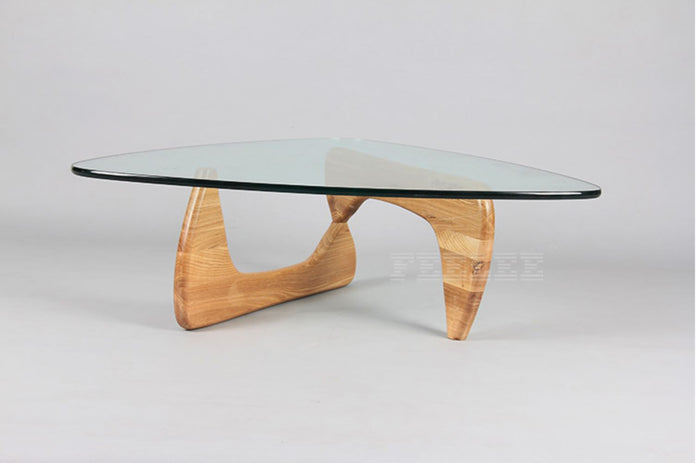 Modern Replica Noguchi coffee table by sue-e furniture featuring a sculptural wooden base and round glass top.