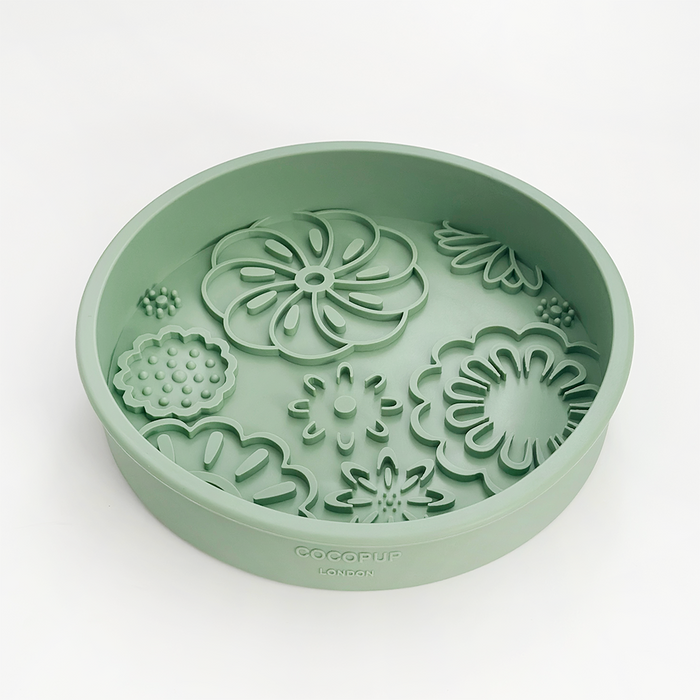 Sage green silicone dog bowl with flower-shaped slow feeder sections.