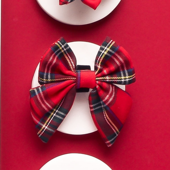 Red plaid and black-white striped Cocopup London tartan sailor bow tie on a white card against a red background.