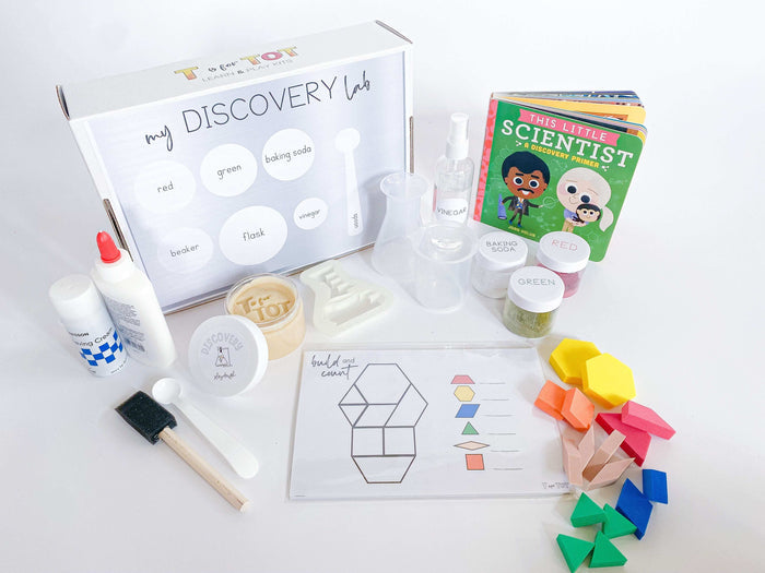 Kids' Discovery Kit with science experiment materials, homemade playdough, and a flask playdough cutter. Features pattern blocks with build-and-count laminated cards, art experiment projects, and a STEAM and recipe card.