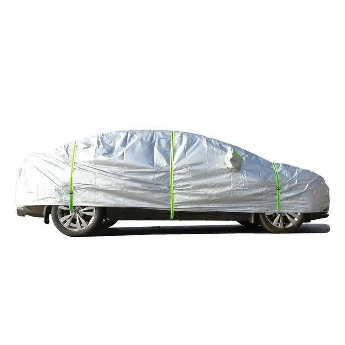 Habicare HBC universal outdoor car cover protecting a silver sedan from weather elements outdoors.