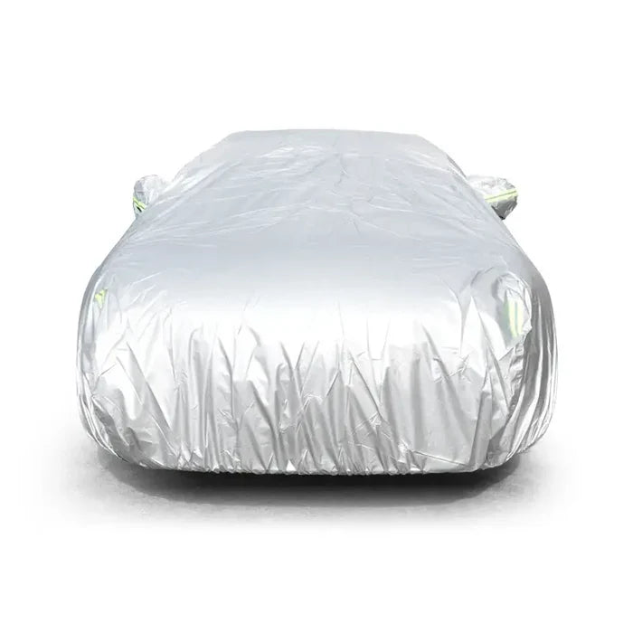 Habicare HBC universal outdoor car cover protecting a car from weather elements and dust in an outdoor setting.