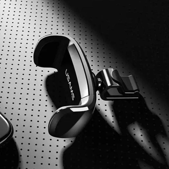 USAMS phone holder from 9eight5 for smartphones and tablets, shown mounted on a desk with adjustable grip for devices.