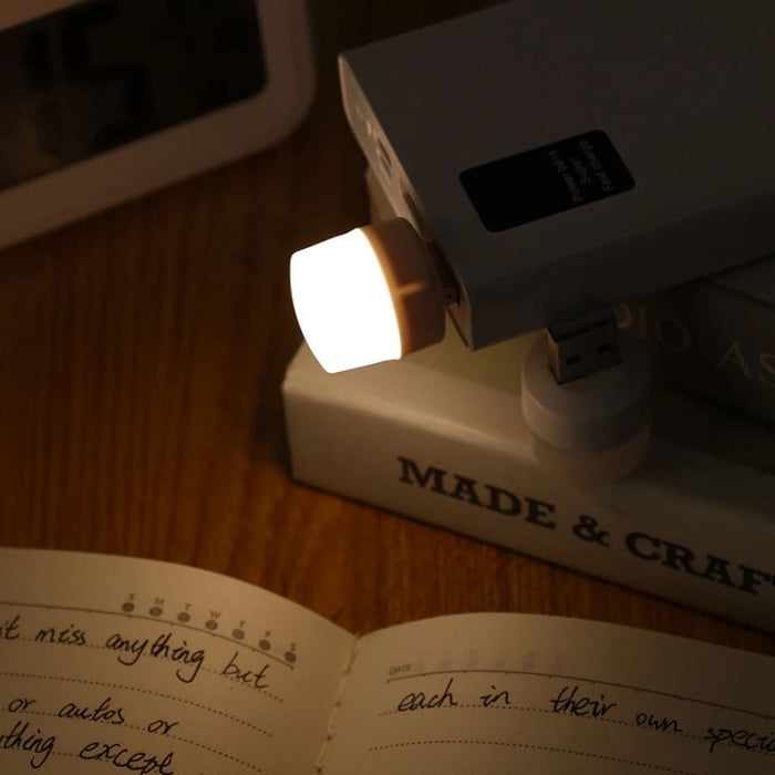 9eight5 USB night light plugged into a power outlet, providing soft illumination in a modern electronic setting.