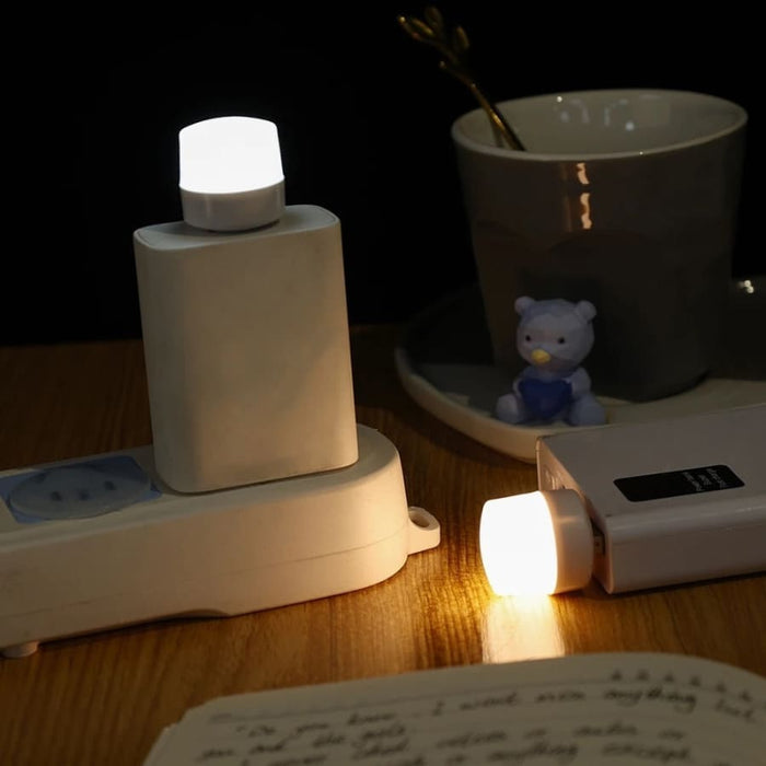9eight5 USB night light plugged into a power outlet, providing soft illumination for electronics and bedside use.