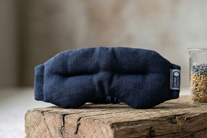 Teal weighted eye mask from Do Not Disturb Sleep Company, designed for relaxation and sleep, with soft fabric and gentle weight.