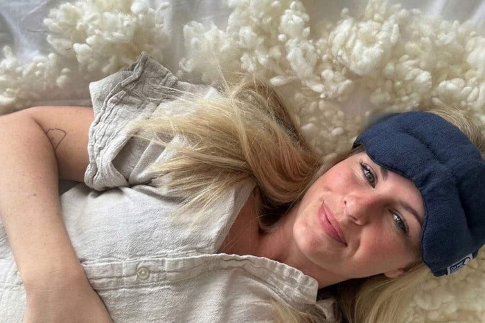 Teal weighted eye mask from Do Not Disturb Sleep Company with soft fabric and adjustable strap for restful sleep.