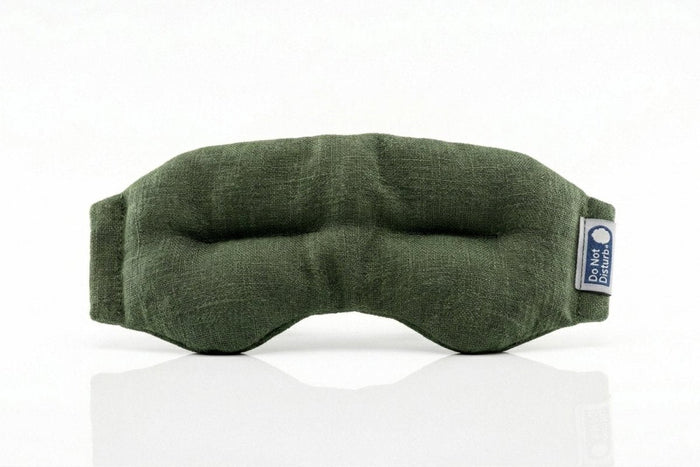 Moss green Do Not Disturb Sleep Company weighted eye mask with soft fabric and adjustable strap for relaxation and sleep comfort.
