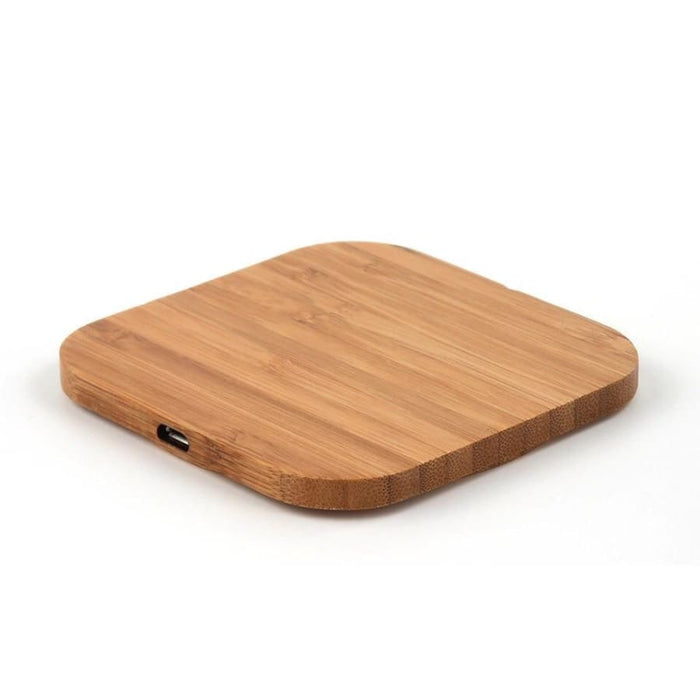 9eight5 wireless charger on hardwood and plywood surface, designed for phone and tablet charging accessories.