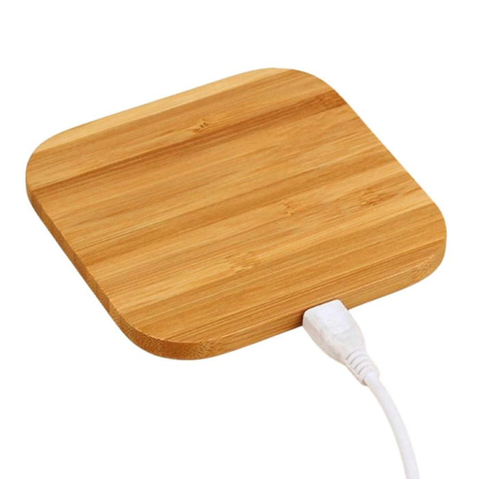 9eight5 wireless charger for phones and tablets on hardwood surface, showcasing sleek, modern design.